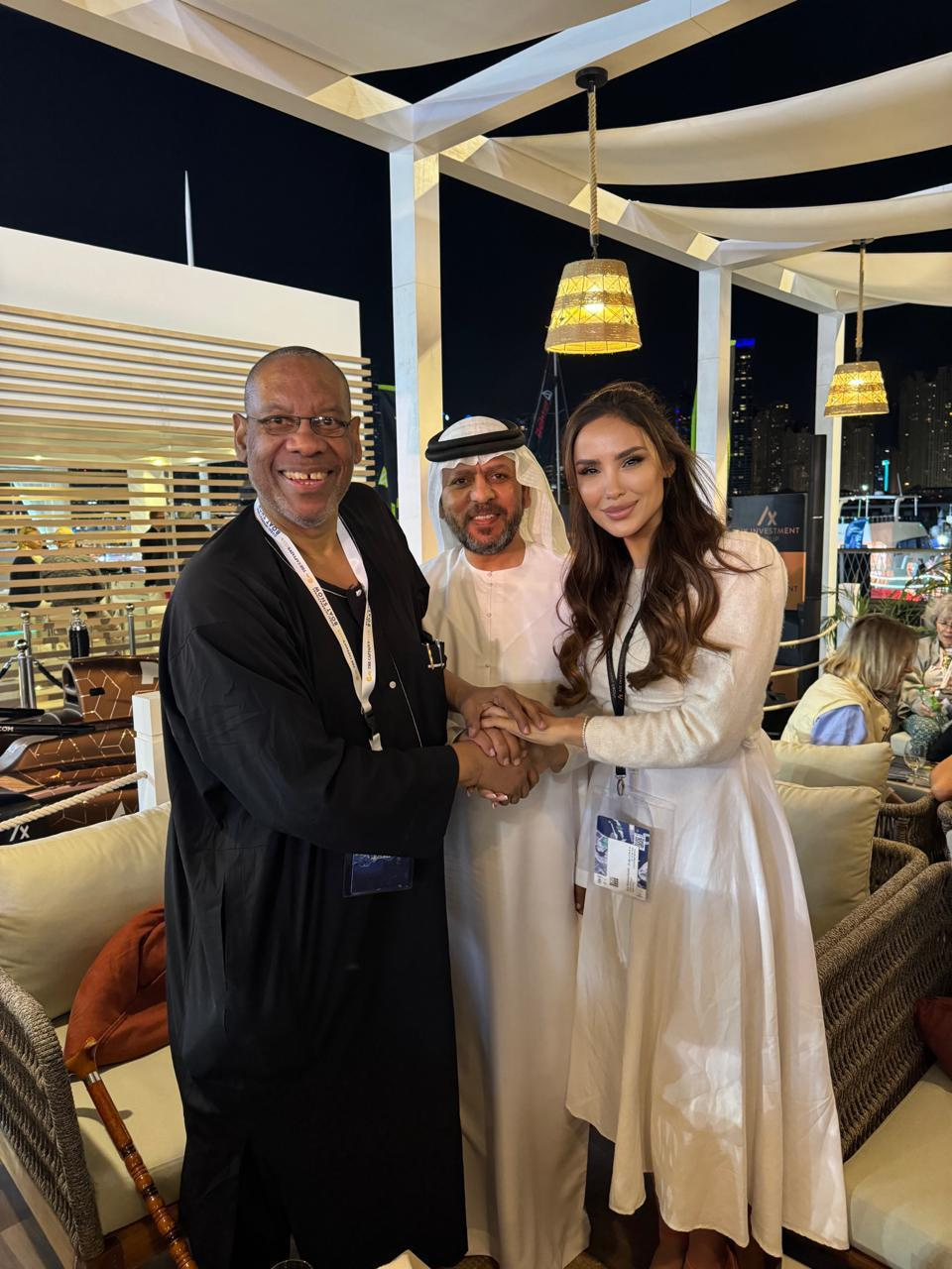 Global Oneness founder shaking hands with partners at an international investment event